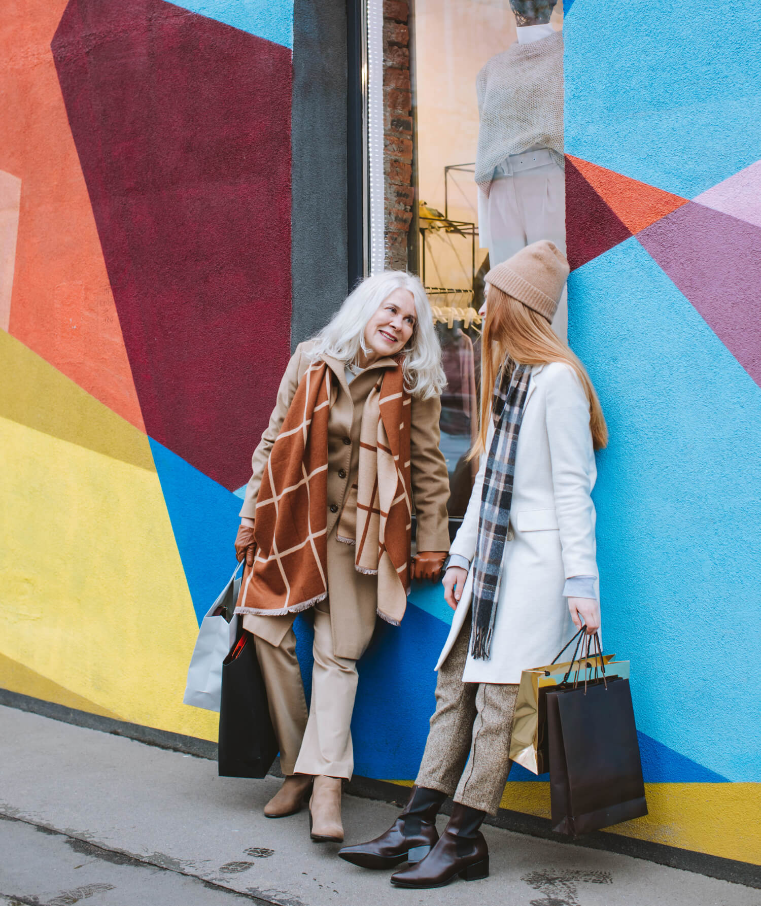 Two women walking with a suitcase